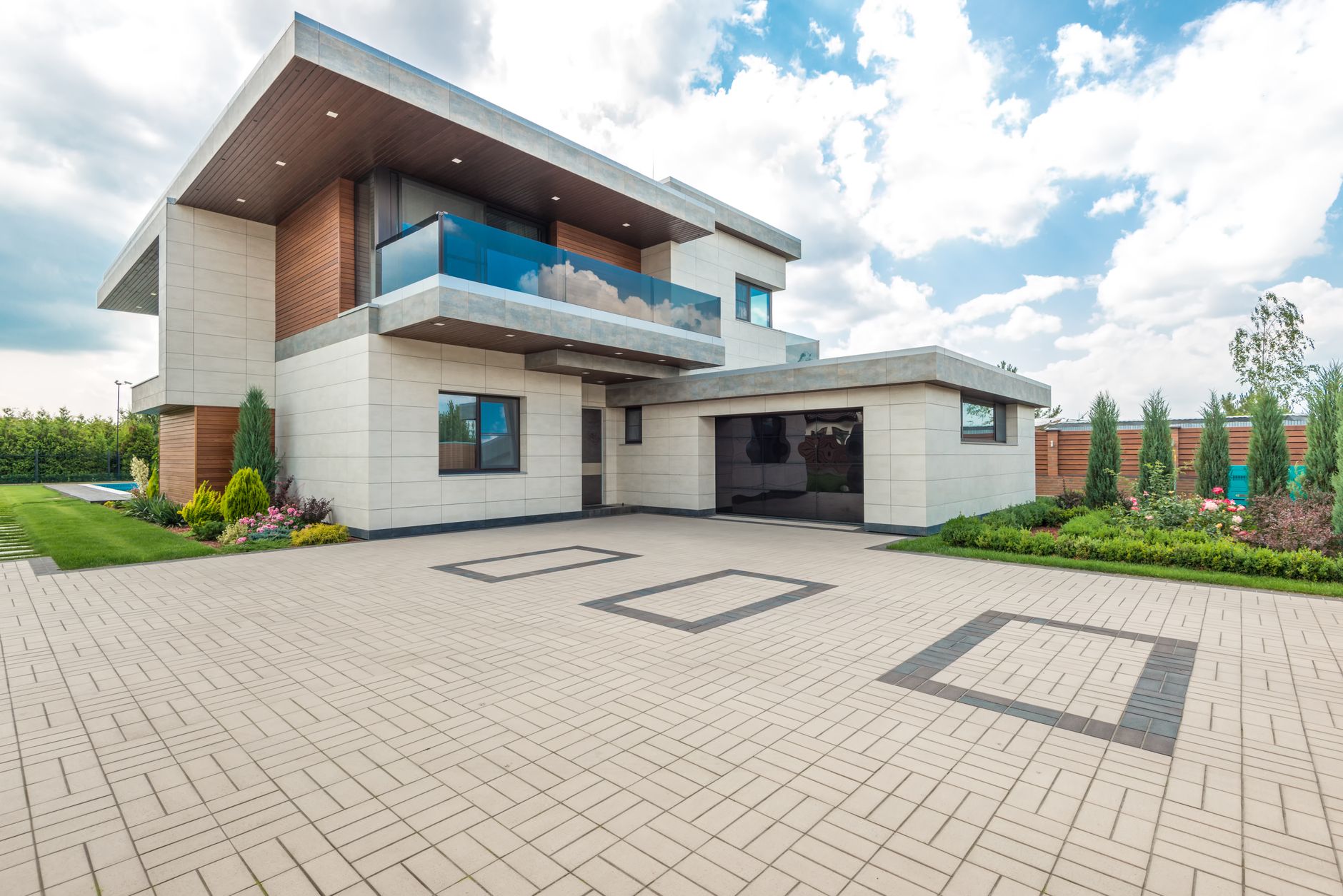 Elegant modern house exterior with lush greenery and ample driveway space